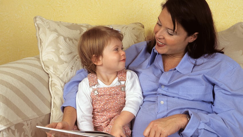 Mother reading to young child