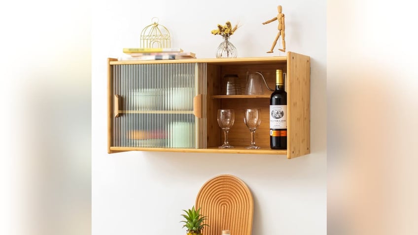 This wall-mounted kitchen cabinet is a great way to store plates.