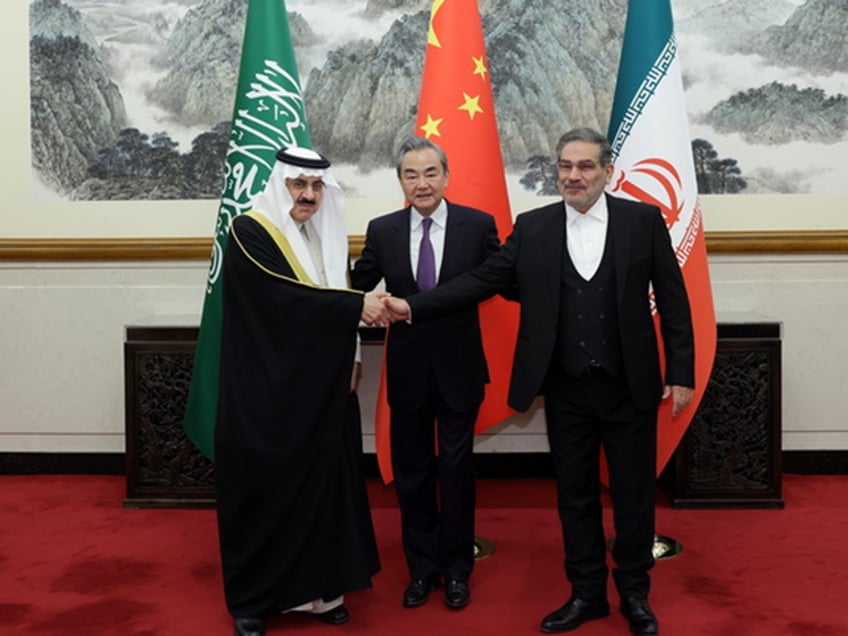 Iran's top security official Ali Shamkhani (R), Chinese Foreign Minister Wang Yi (C) and Musaid Al Aiban, the Saudi Arabia's national security adviser pose for a photo after Iran and Saudi Arabia have agreed to resume bilateral diplomatic ties after several days of deliberations between top security officials of the two countries in Beijing, China on March 10, 2023. (Photo by CHINESE FOREIGN MINISTRY/Anadolu Agency via Getty Images)