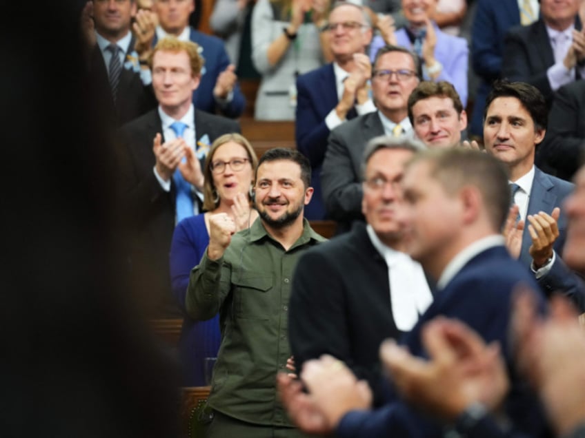 Ukrainian President Volodymyr Zelensky (C) with Canadian Prime Minister Justin Trudeau (R), acknowdledges a Canadian-Ukrainian war veteran after addressing the House of Commons in Ottawa, Canada, on September 22, 2023. (Photo by Sean Kilpatrick / POOL / AFP) (Photo by SEAN KILPATRICK/POOL/AFP via Getty Images)