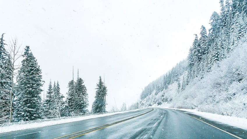 Empty road with snow covered landscape in winter season..