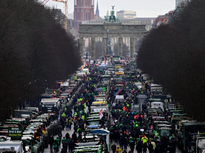 Tractors and trucks stand in front of Berlin's landmark the Brandenburg Gate during a protest of farmers and truck drivers, on January 15, 2024 in Berlin. The farmers' and truck drivers' anger stems from a government decision to cut subsidies and tax breaks on diesel and agricultural vehicles. The move …