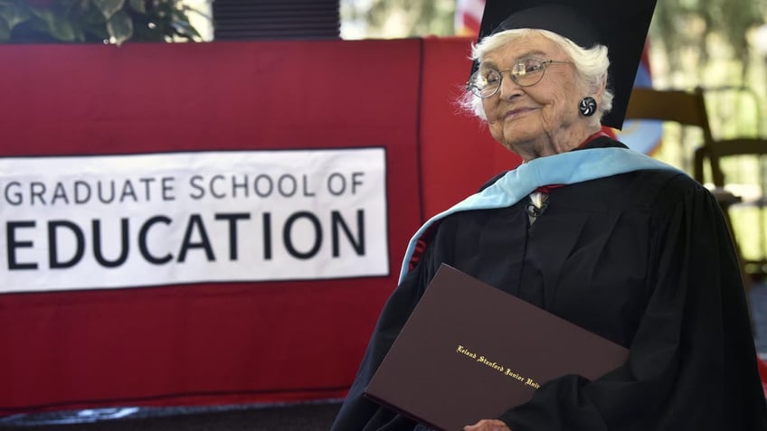 Virginia Hislop, 105, holds her diploma after graduating from Stanford University's Graduate School of Education.