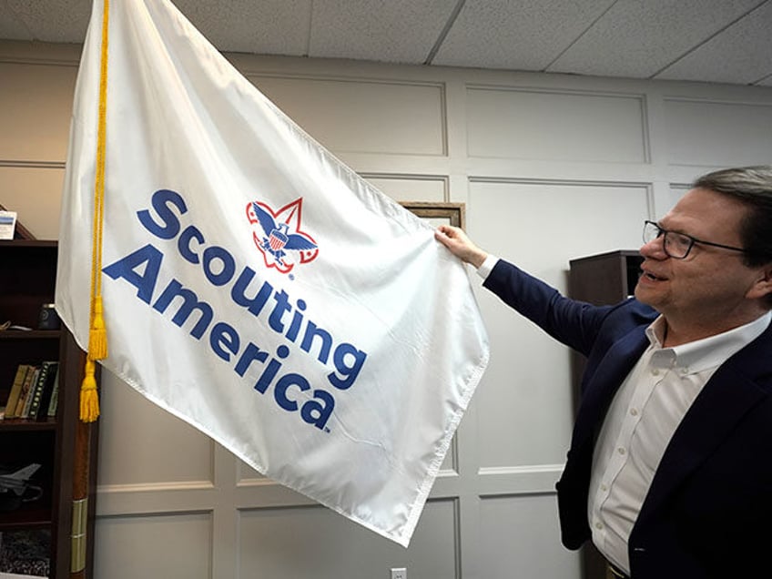 Michael Ramsey displays the Scouting America flag at the organization's headquarters in Ir