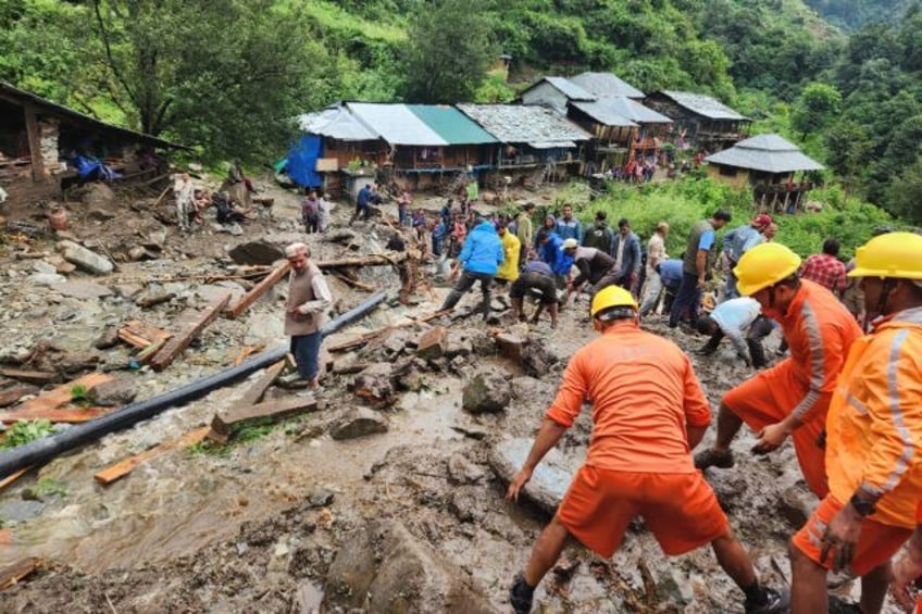 A handout picture from India's National Disaster Response Force shows rescue workers clear