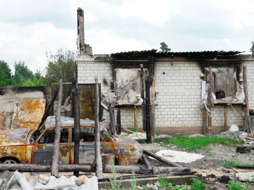 TOPSHOT - Local resident Mikhail looks out from his house destroyed by Ukrainian strikes in the village of Novaya Tavolzhanka, near the border with Ukraine in the Belgorod region, on July 4, 2023. (Photo by STRINGER / AFP) (Photo by STRINGER/AFP via Getty Images)