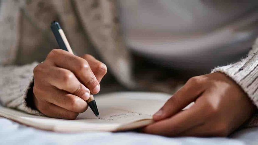 Person writing in journal