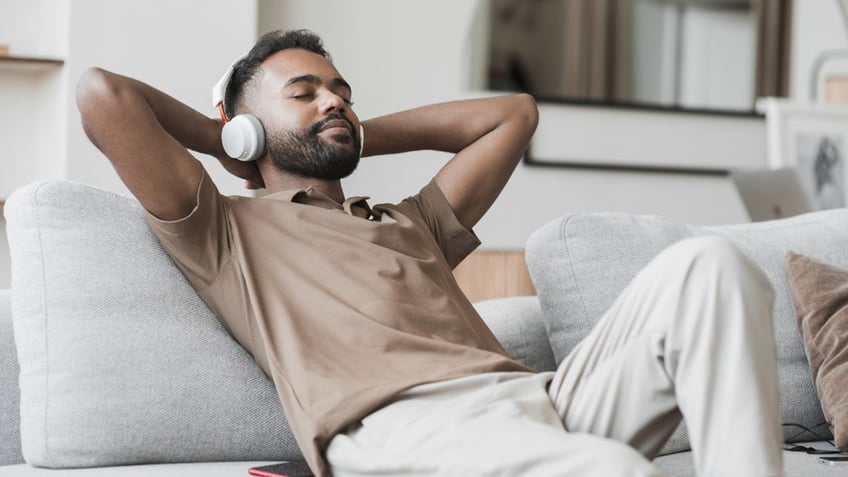 Man listening to music on the couch