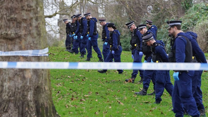 Police officers conduct search