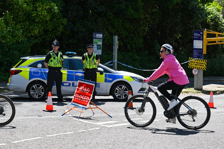 BOURNEMOUTH, ENGLAND - MAY 25: Police officers at the closed road leading to Durley Chine Beach, on May 25, 2024 in Bournemouth, England. Dorset Police have launched a murder inquiry into the death of a woman stabbed on Friday night on Durley Chine Beach. Two women were found with stab wounds, one died at the scene. (Photo by Finnbarr Webster/Getty Images)