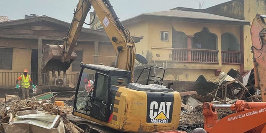 2 dead in nigeria after building collapses many more may be trapped under rubble