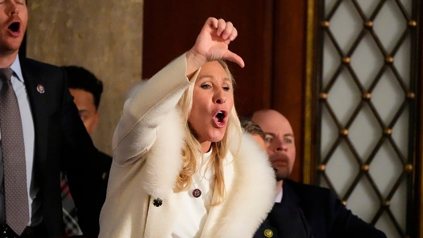 Rep. Marjorie Taylor Greene yells in the chambers as President Joe Biden