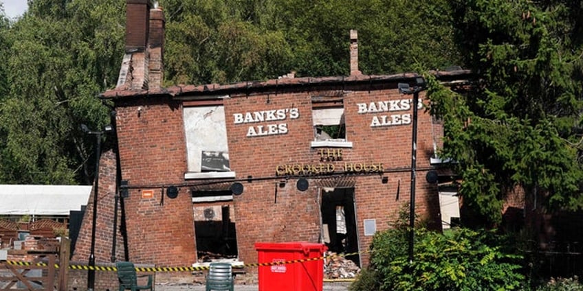 2 men arrested accused of arson attack on englands crooked house pub