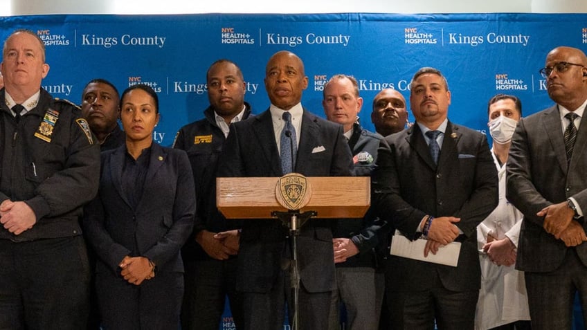 NYC Mayor Eric Adams speaks at a press briefing flanked by NYPD cops