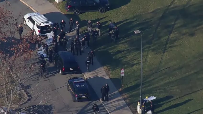 Police gather outside a school in New York