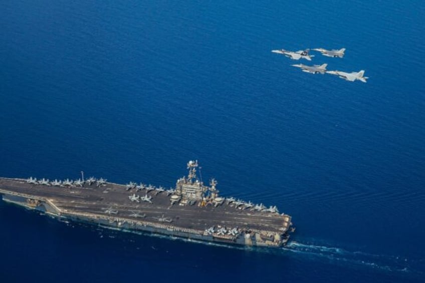 A handout file picture from the US Navy showing the USS Harry S Truman with F/A-18 and F-1