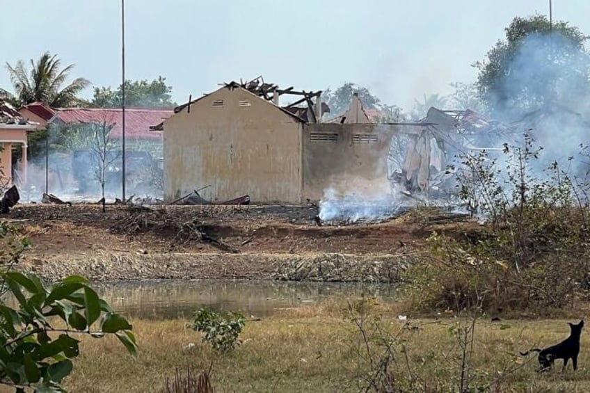 Smoke billows from a warehouse following an explosion at an army base in Cambodia