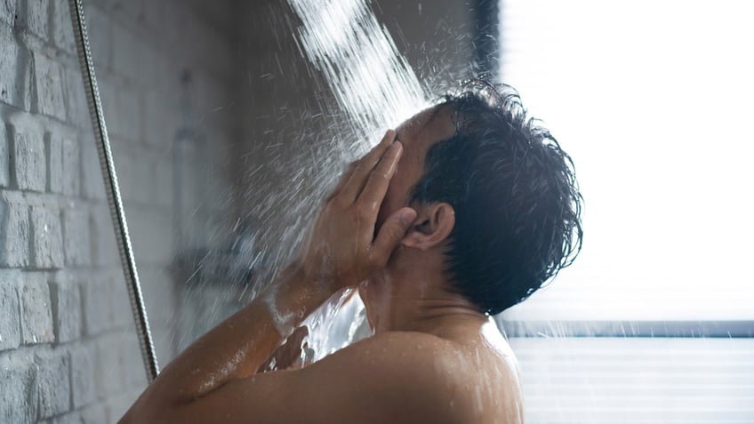 Man showering with hot water