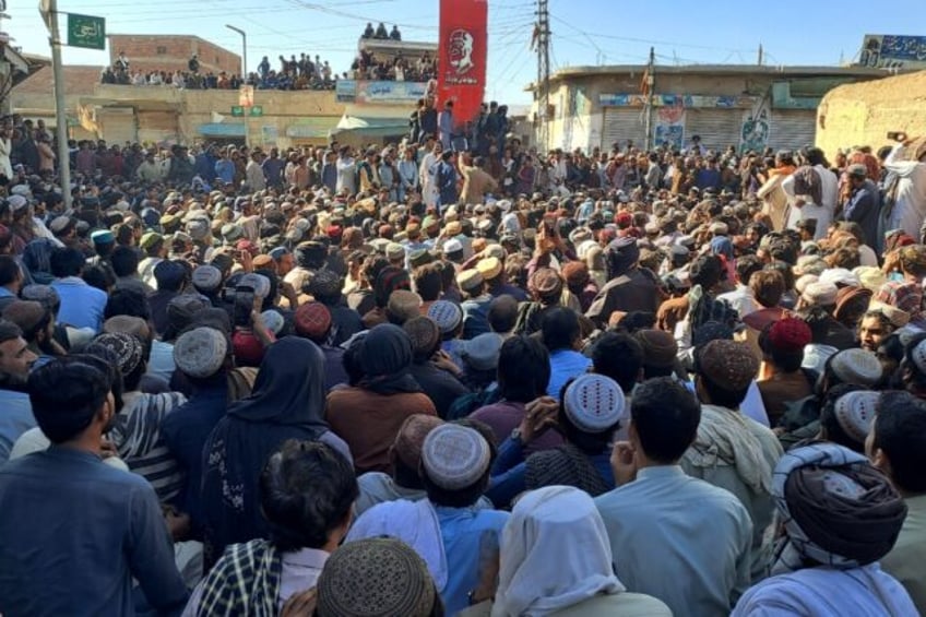 Labourers gather to protest against the killings of coal miners in an overnight attack in