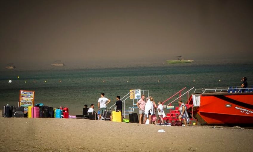 2000 people including tourists evacuated as a wildfire rages on the greek island of rhodes