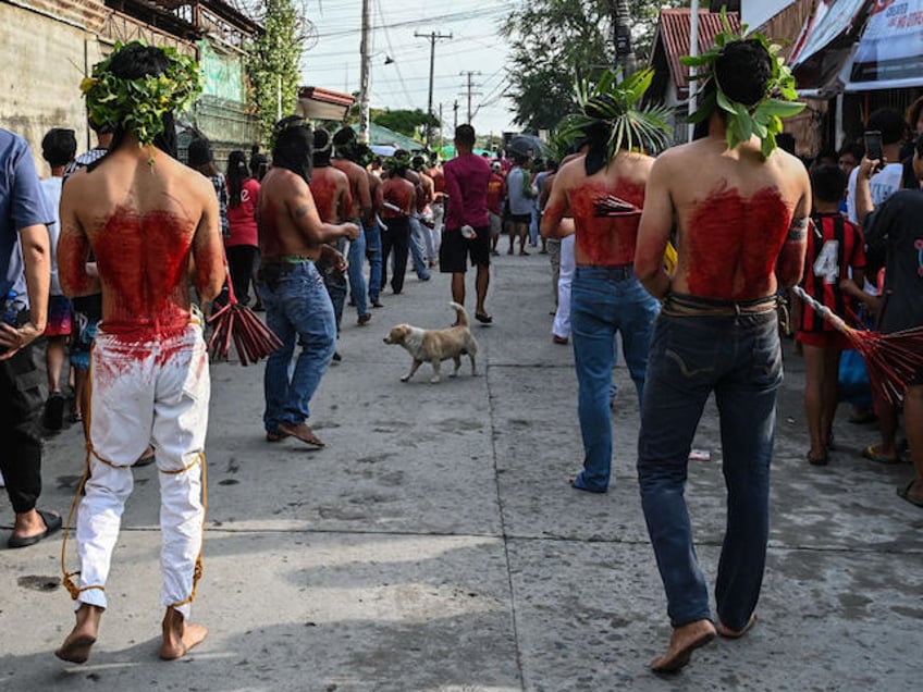 Penitents flagellate themselves during Good Friday as part of Holy Week celebrations in San Fernando, Pampanga province on March 29, 2024. (Photo by JAM STA ROSA / AFP)