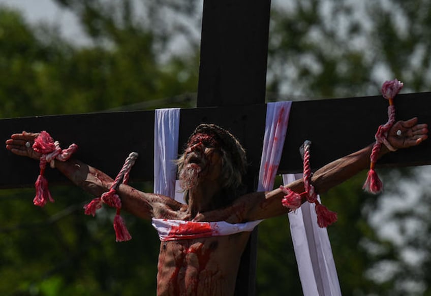 Philippine Christian devotee Wilfredo Salvador takes part in the re-enactment of the crucifixion of Jesus Christ on Good Friday in San Fernando, Pampanga province on March 29, 2024. (Photo by JAM STA ROSA / AFP)