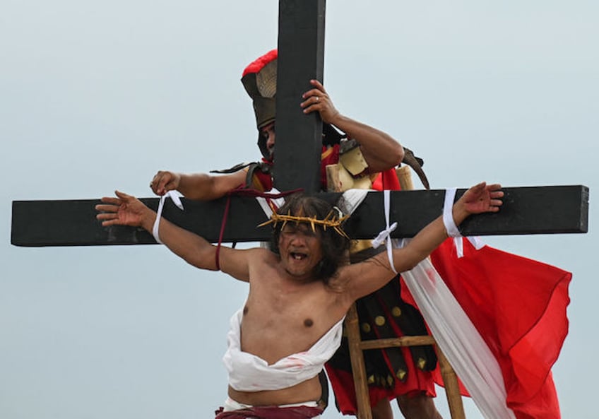 Philippine Christian devotee Ruben Enaje performs his 35th re-enactment of the crucifixion of Jesus Christ on Good Friday in San Fernando, Pampanga province on March 29, 2024. (Photo by JAM STA ROSA / AFP)