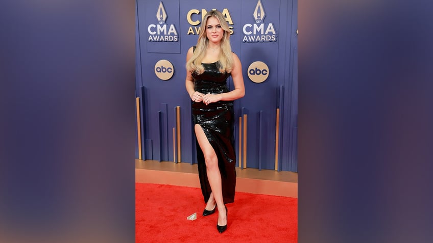 Alana Springsteen wore a sequined black dress with a high slit to the 2024 CMA Awards.