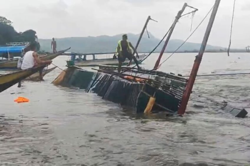 21 dead and 40 rescued after a wind tossed boat overturns in the philippines