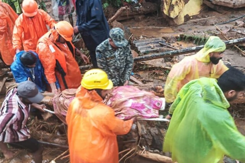 Photos released by India's National Disaster Response Force show personnel carrying victim