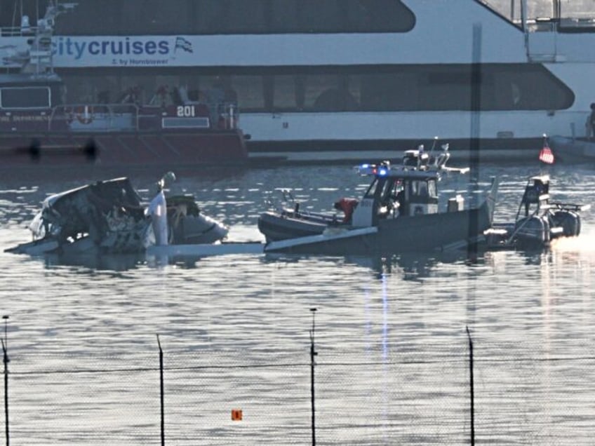 ARLINGTON, VIRGINIA - JANUARY 30: Emergency response units search the crash site of the A