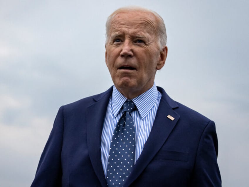 US President Joe Biden walks over to talk to reporters after stepping off Air Force One at