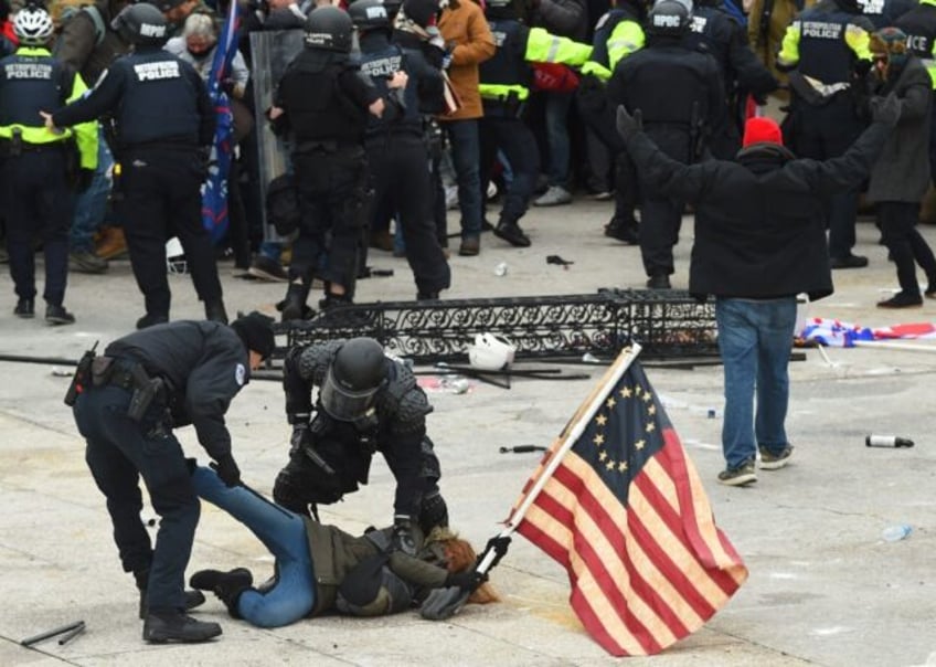 Police detain a person as supporters of US President Donald Trump protest outside the US Capitol on January 6, 2021, in Washington