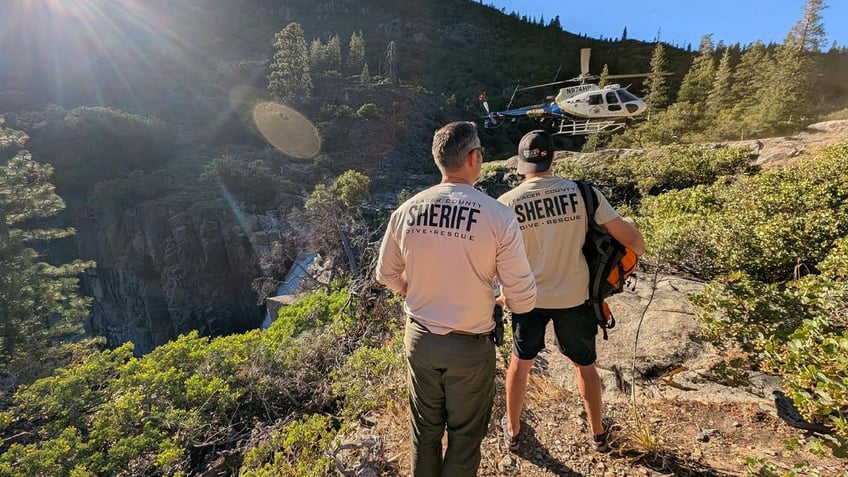 Law enforcement officials searching for three missing hikers