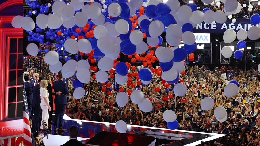 Republican presidential nominee and former U.S. President Donald Trumps family joins him onstage as balloons fall after his speech on Day 4 of the Republican National Convention