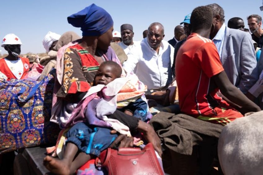 Britain's Foreign Secretary David Lammy (CR) visits the Border Bridge in Adre, Chad, where