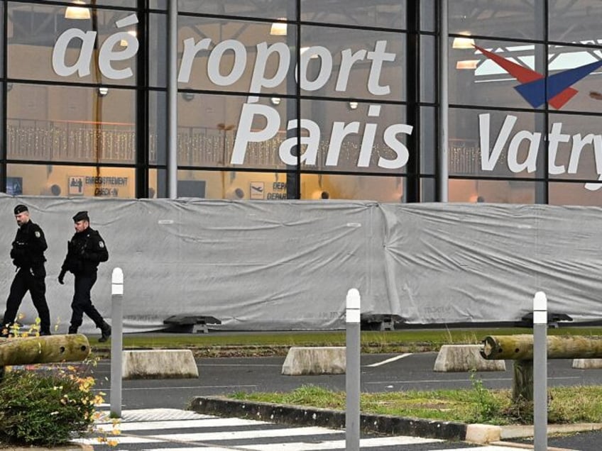 French gendarmes patrol around a terminal at Vatry airport, north-eastern France, on December 23, 2023 two days after officials grounded a Nicaragua-bound plane carrying more than 300 Indian passengers over suspected "human trafficking". The Airbus A340 has been held at Vatry airport, 150 kilometres (95 miles) east of Paris, since …