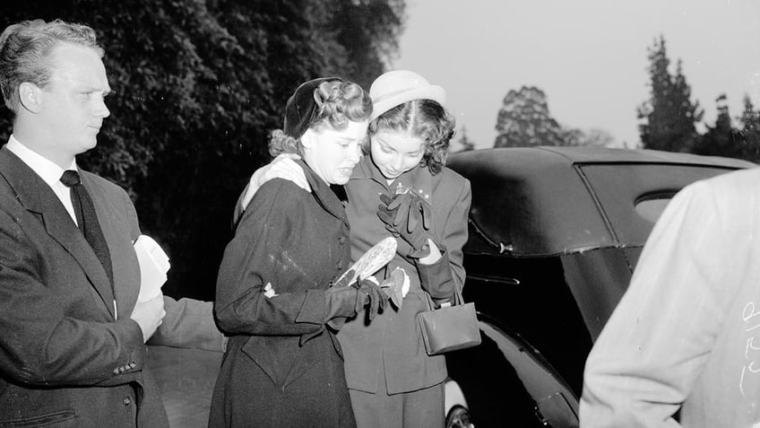 Two women mourning at Warner Baxters funeral