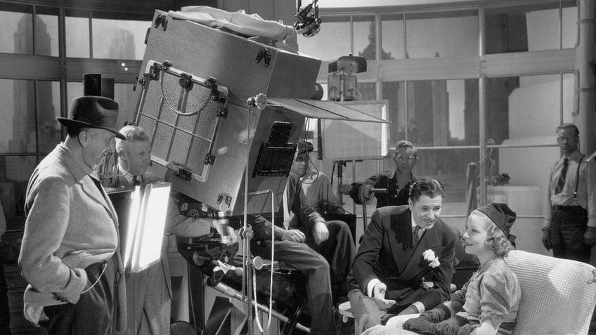 Warner Baxter filming a movie behind the scenes.