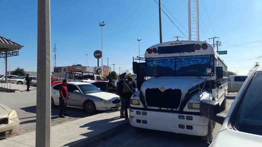 authorities standing outside bus