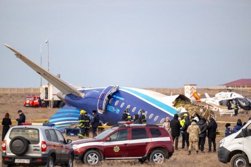 Emergency specialists work at the crash site