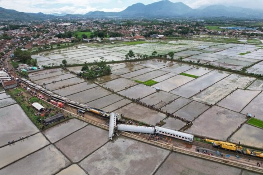 Four people were killed and at least 22 injured when two trains carrying hundreds of passengers collided in Indonesia