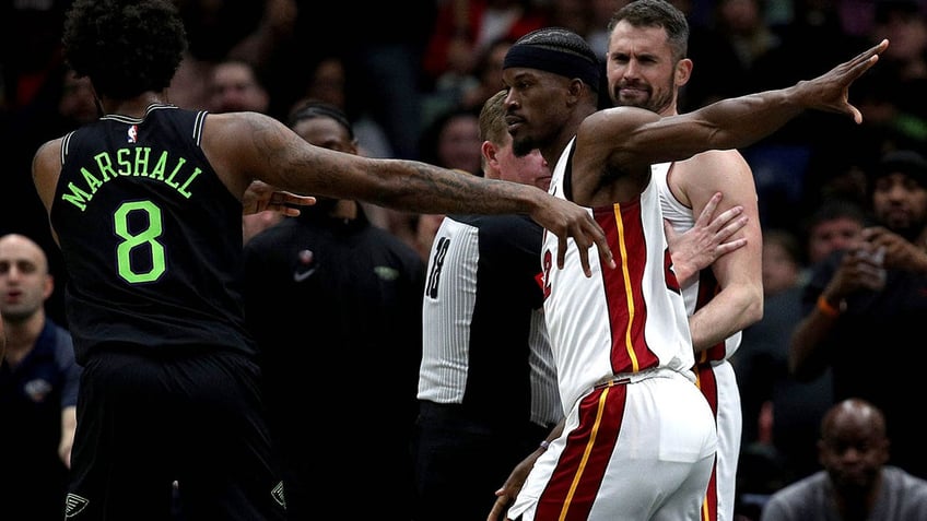 Jimmy Butler shooing Naji Marshall