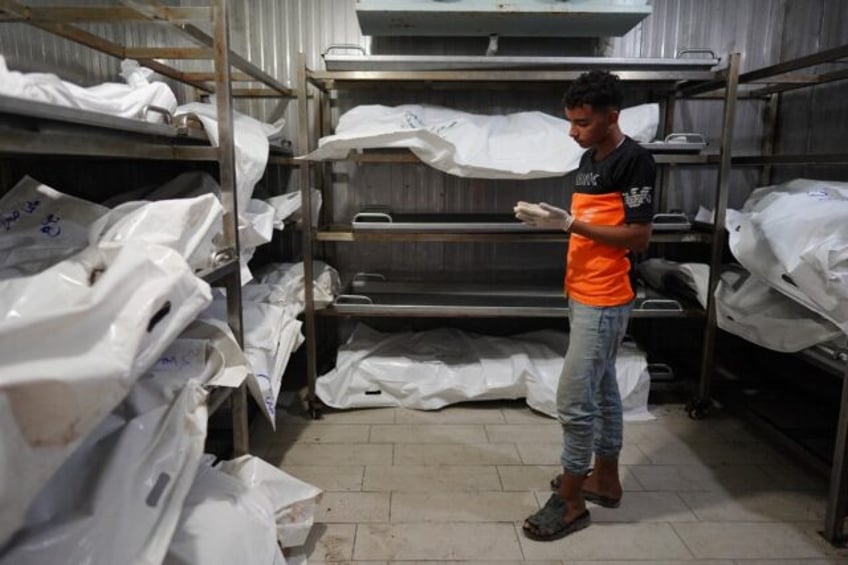 A young Palestinian who works with his father at the morgue at the Nasser Hospital in sout