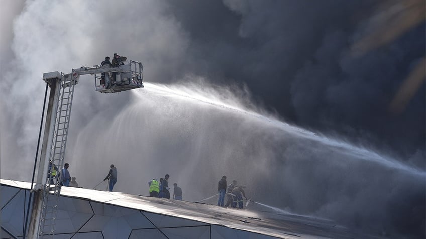 Firefighters dousing a building fire in Kuwait.