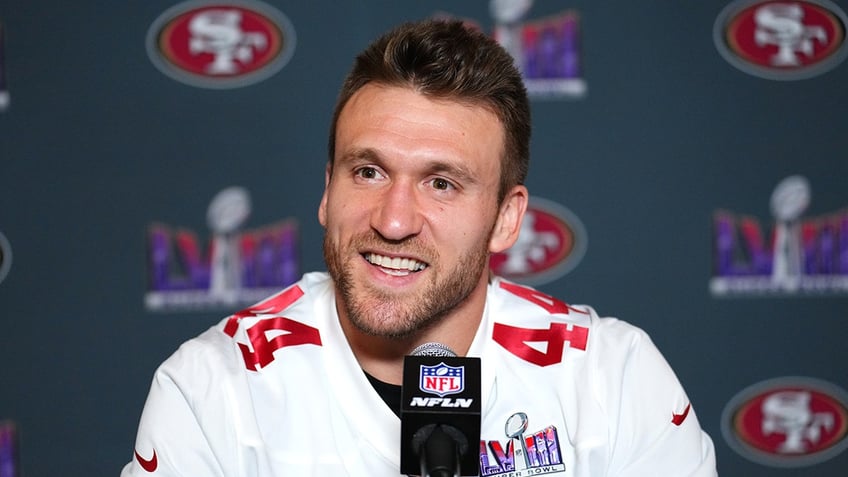 Kyle Juszczyk smiles at podium