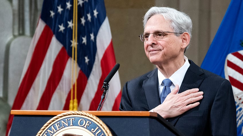 Merrick Garland at DOJ lectern with US flag behind him