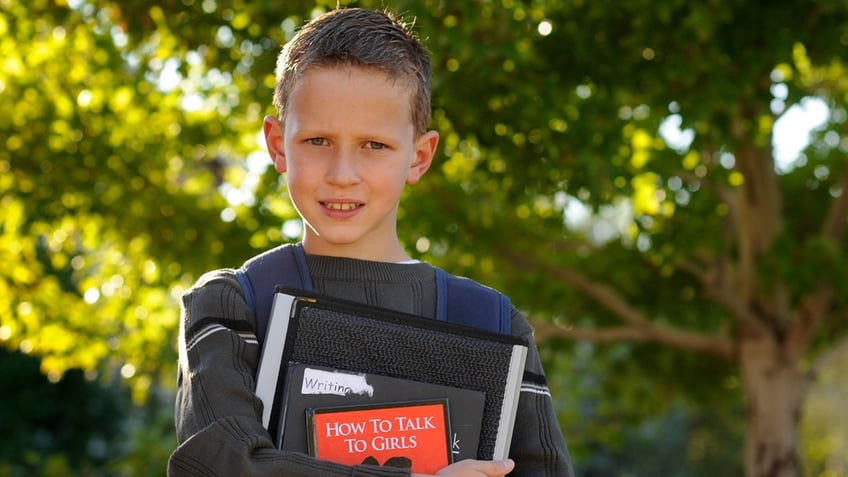 Child author Alec Greven holding book