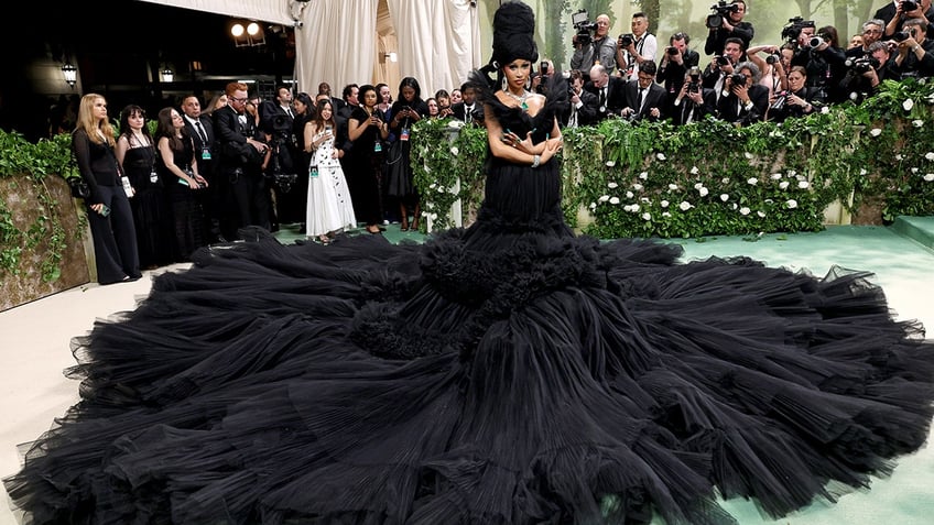 Cardi B at the Met Gala 2024 red carpet wearing a voluminous black tulle ball gown.