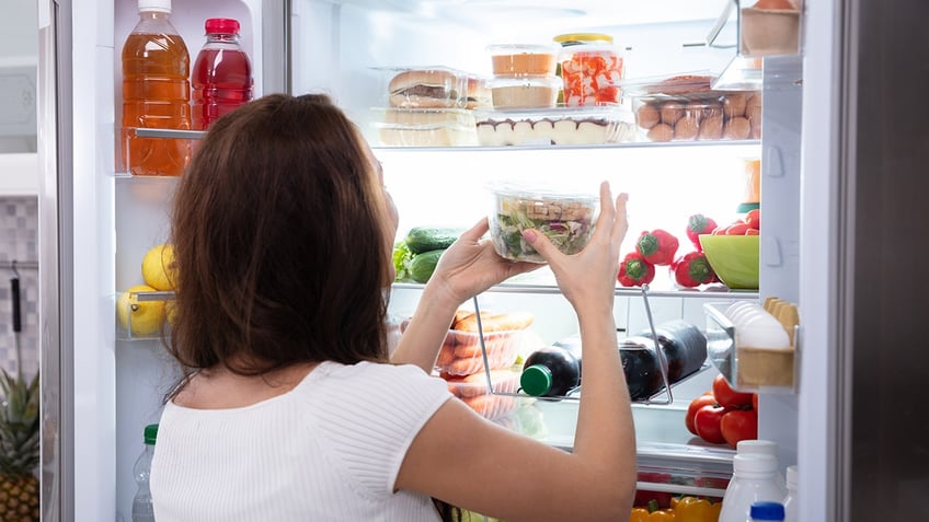 woman with open refrigerator